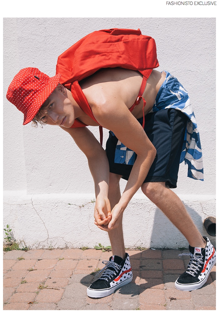 Cameron wears shorts Patrik Ervell, bucket hat Undefeated, shirt worn around waist Gitman Bros., shoes Stussy x VANS and backpack Herschel Supply Co.