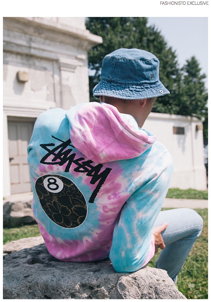 Zak wears tie-dye hoodie Stussy, jeans and vintage denim bucket hat Levi's.