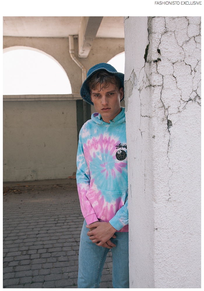 Zak wears tie-dye hoodie Stussy, jeans and vintage denim bucket hat Levi's.