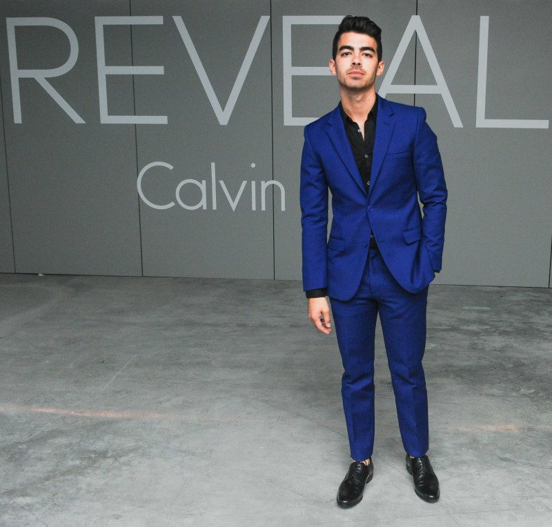 Joe Jonas was on hand last night to help Calvin Klein celebrate the launch of its new fragrance 'Reveal'. For the New York event, Jonas was outfitted by Calvin Klein Collection, wearing a rich tailored blue suit.