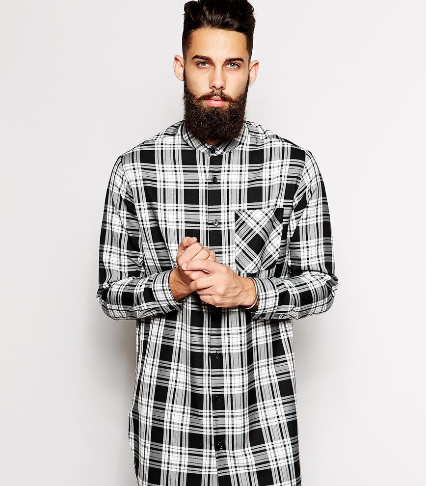 Checked button-downs are timeless and a great standby, but how do you make them modern and really stand out? Embrace the longline fit. Cut longer and instantly more dramatic, the modern fit looks great with a pair of skinny jeans. Reclaimed vintage extreme longline checked shirt with granddad collar from ASOS.