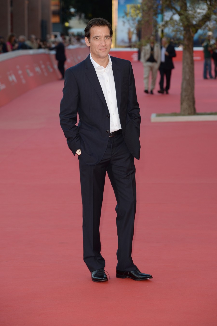 Heading to the Rome Film Festival, actor Clive Owen hit the red carpet at a screening of his new television series 'The Knick'. For the special event, Owen was outfitted by Italian label Giorgio Armani, wearing a navy suit with a pristine white dress shirt.