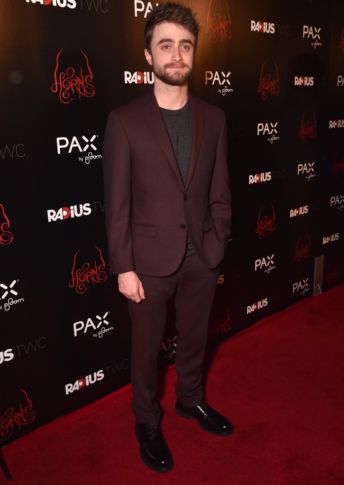 Relaxed in burgundy, Daniel Radcliffe paired a slim-cut suit with a simple t-shirt for the Los Angeles premiere of 'Horns' on October 30th.
