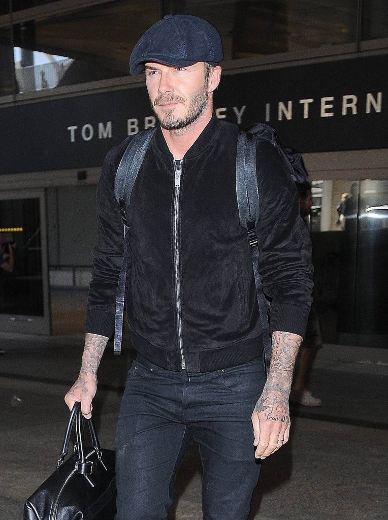 Spotted leaving LAX on October 16th, David Beckham was in impressive travel style. Beckham paired a driver's cap and a dark pair of slim-fit jeans with a suede bomber jacket.