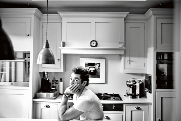 David Gandy relaxes in his tidy kitchen.