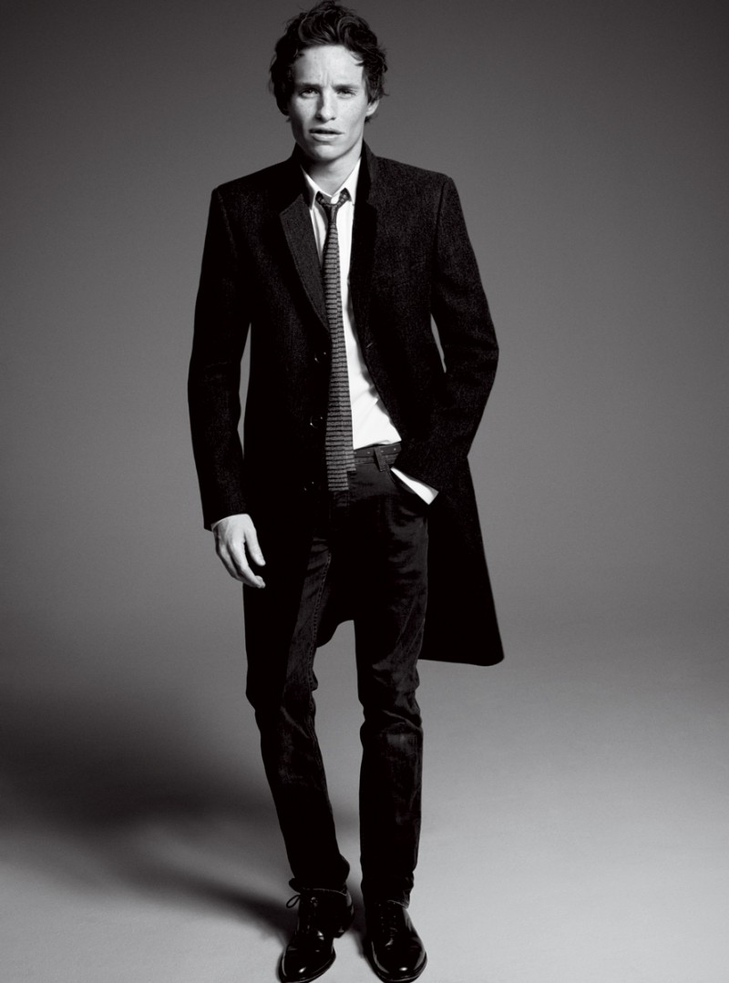 Eddie Redmayne wears coat and tie Saint Laurent by Hedi Slimane, shirt Dior Homme, jeans Burberry Brit and shoes Church's. Photo by David Sims.