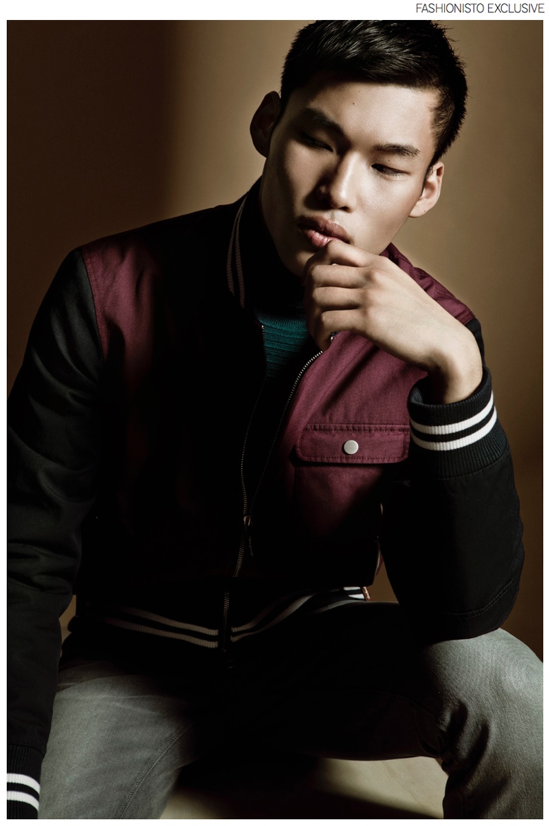 Chun wears varsity jacket GANT, turtleneck sweater Boss by Hugo Boss and trousers Levi's.