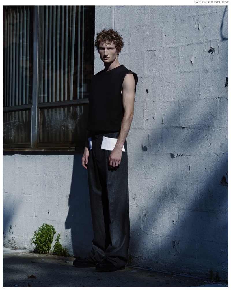 Luke wears neoprene sleeveless sweatshirt Gucci and wool trousers Givenchy by Riccardo Tisci.