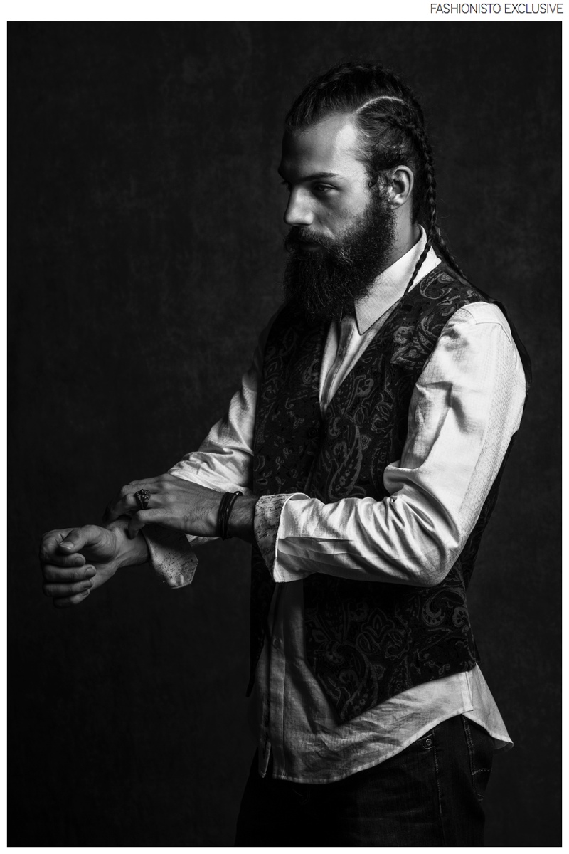 Phil wears vest Luchiano Visconti, leather wrap bracelet model's own, jewelry John Hardy, shirt and jeans Robert Graham.