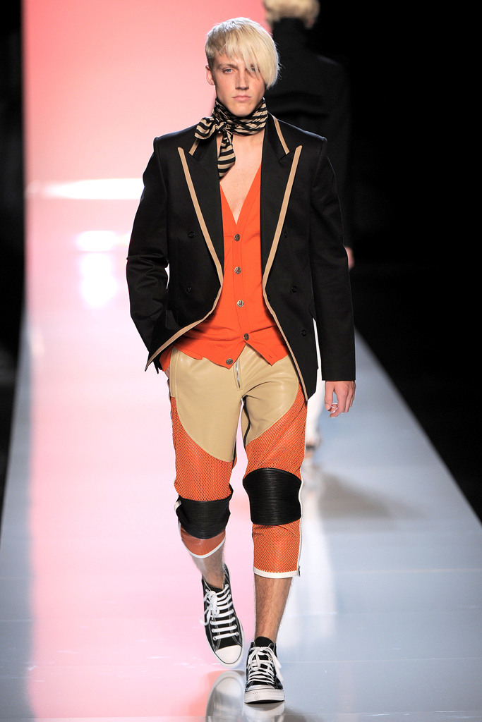 Spring 2010: Mixing sports and fashion, Gaultier presents his interpretation on moto-style with grand colors and bold fits.