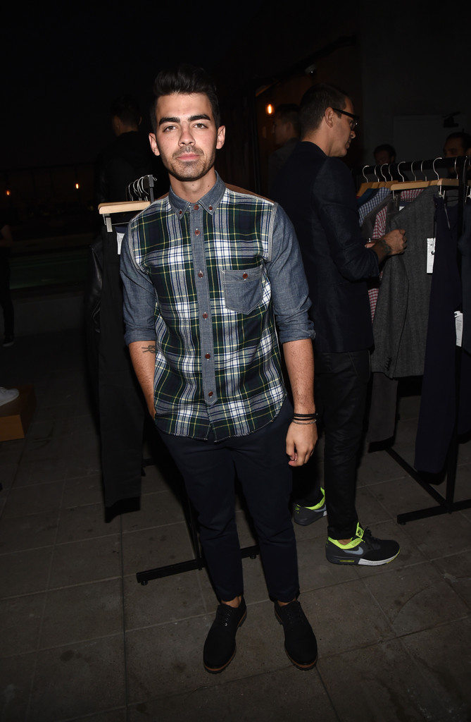 On September 29, 2014, Joe Jonas attended GQ and Gap's celebration of the best new menswear designers in America. For the special occasion at the Ace Hotel, Jonas paired a cord, plaid and denim hybrid shirt with a simple pair of slim-fit pants.