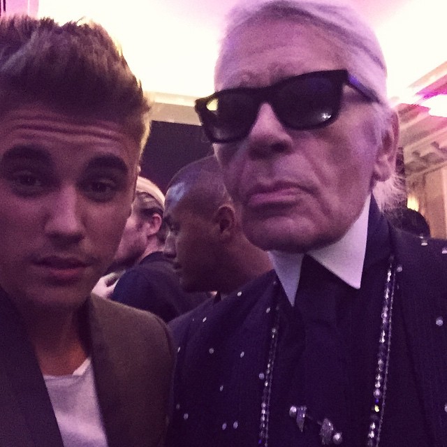 Justin Bieber poses for a photo with designer and photographer Karl Lagerfeld at a party hosted by CR Fashion Book. Pictured, Bieber wears Balmain while Lagerfeld sports Dior Homme.