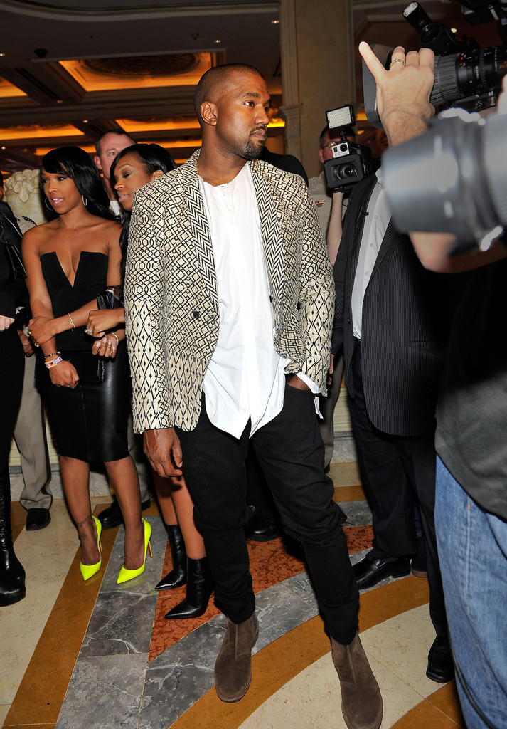 Celebrating Kim Kardashian's 34th birthday on October 25th at Tao Nightclub at The Venetian Las Vegas, rapper Kanye West wore a Haider Ackermann Montalto jacket with black pants, a white, loose shirt and brown suede boots.