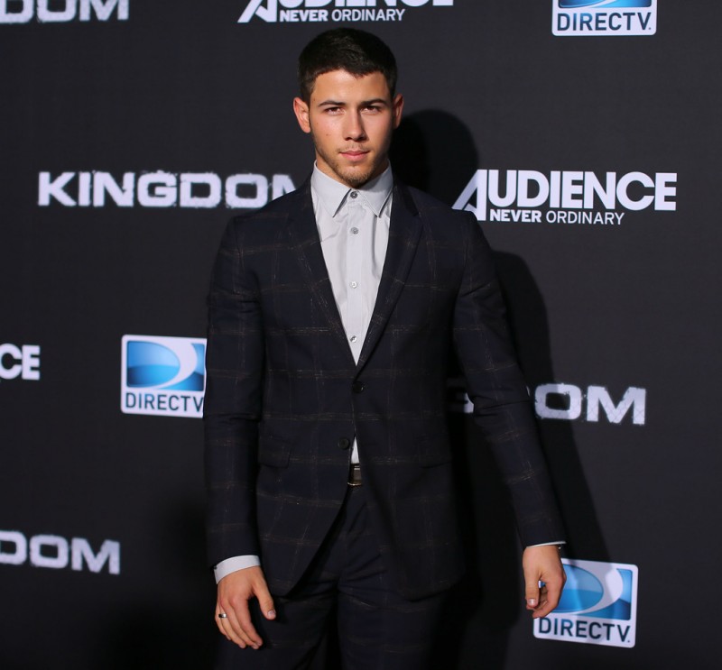 Attending the premiere event for 'Kingdom' in Venice, California on October 1, 2014, Nick Jonas was a dapper vision in a tonal windowpane print suit, worn with a light gray dress shirt.
