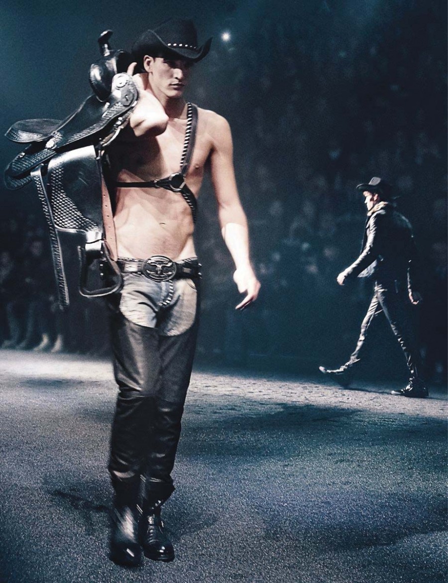 Philipp Plein looks to its January runway show for an image to encompass its fall-winter 2014 campaign. Model Dominik Bauer dons leather chaps and a harness with a cowboy hat.