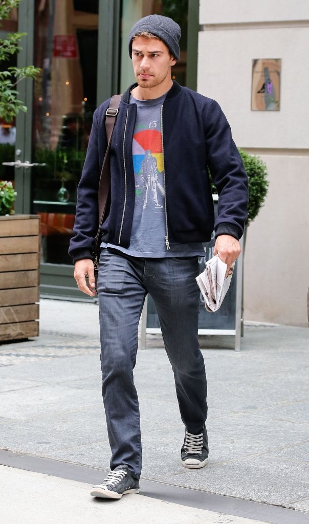 Captured on the streets of New York City on October 2, 2014, 'Divergent' actor Theo James kept warm on the cool day in a bomber jacket with jeans, a casual t-shirt and a gray knit beanie.