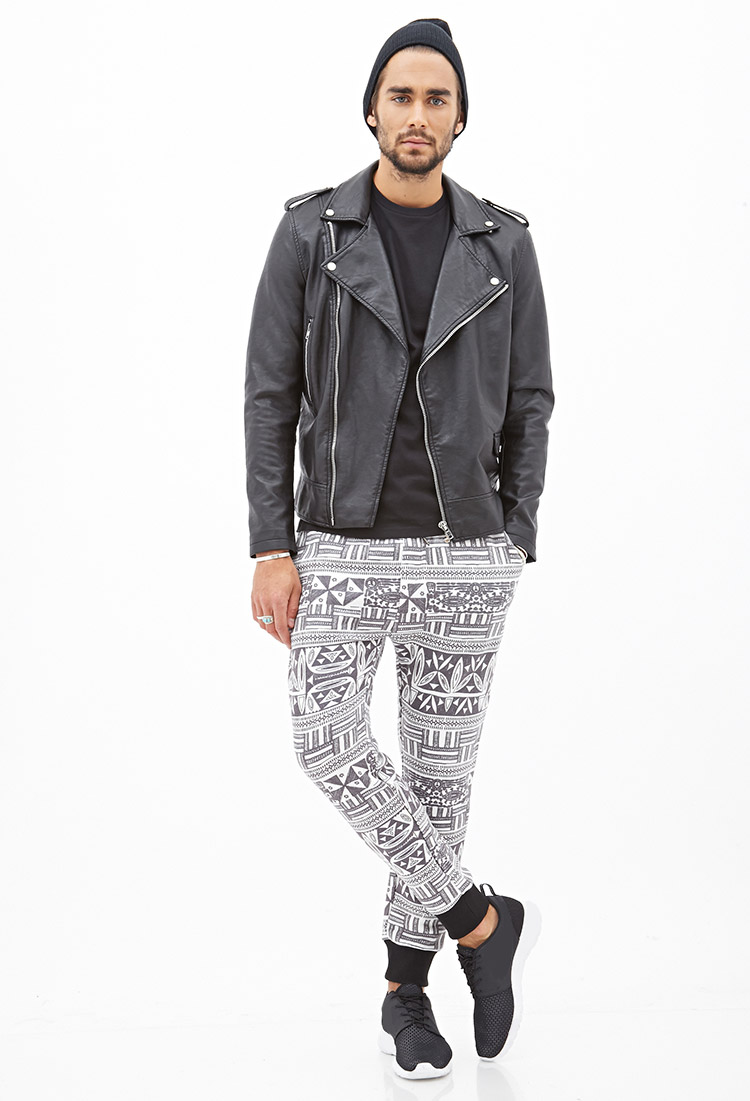 Nicolas wears tribal print sweatpants.