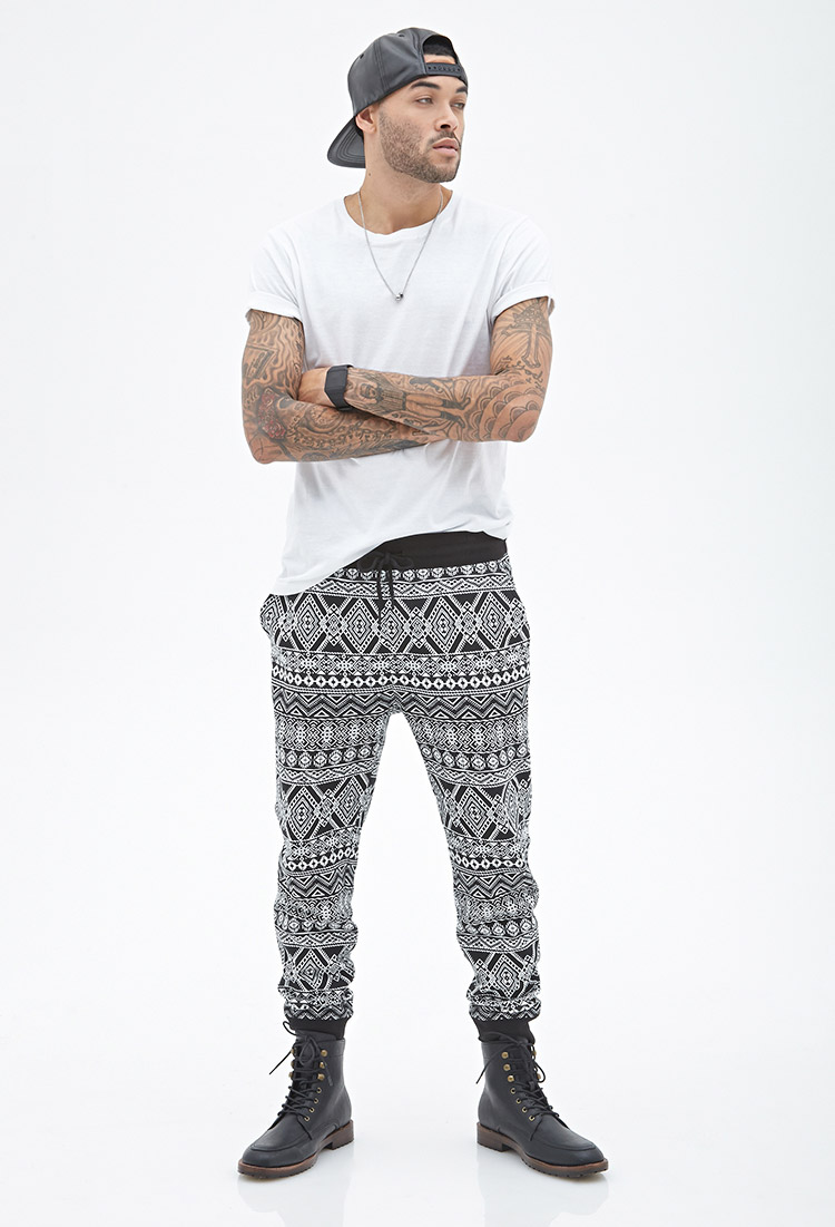 Don wears tribal print sweatpants.