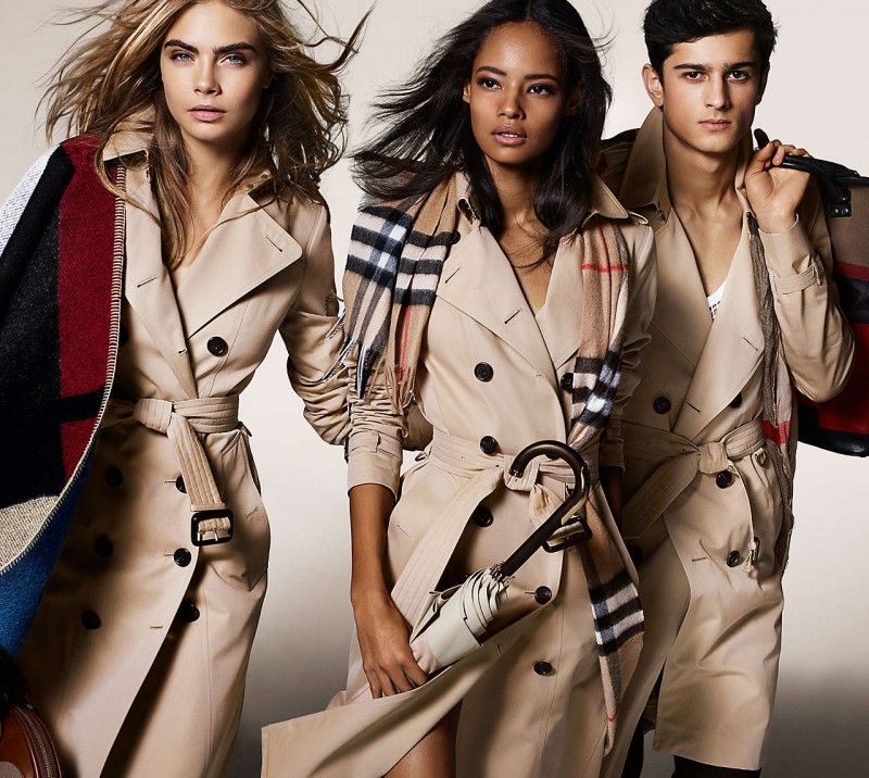 Models Cara Delevingne, Malaika Firth and Tarun Nijjer sport Burberry's iconic trench coats in the label's fall-winter 2014 campaign, lensed by fashion photographer Mario Testino.