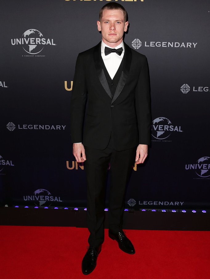 Touching down in Sydney, Australia for the November 17th premiere of 'Unbroken', British actor Jack O'Connell wore a slim-cut, three-piece tuxedo from Italian fashion house Prada.