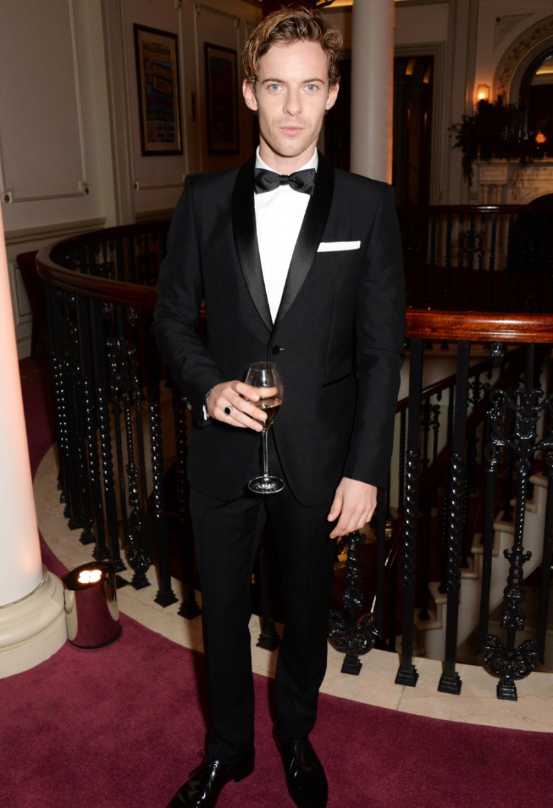 Donning a Burberry evening look, Luke Treadaway enjoys a glass of champagne.