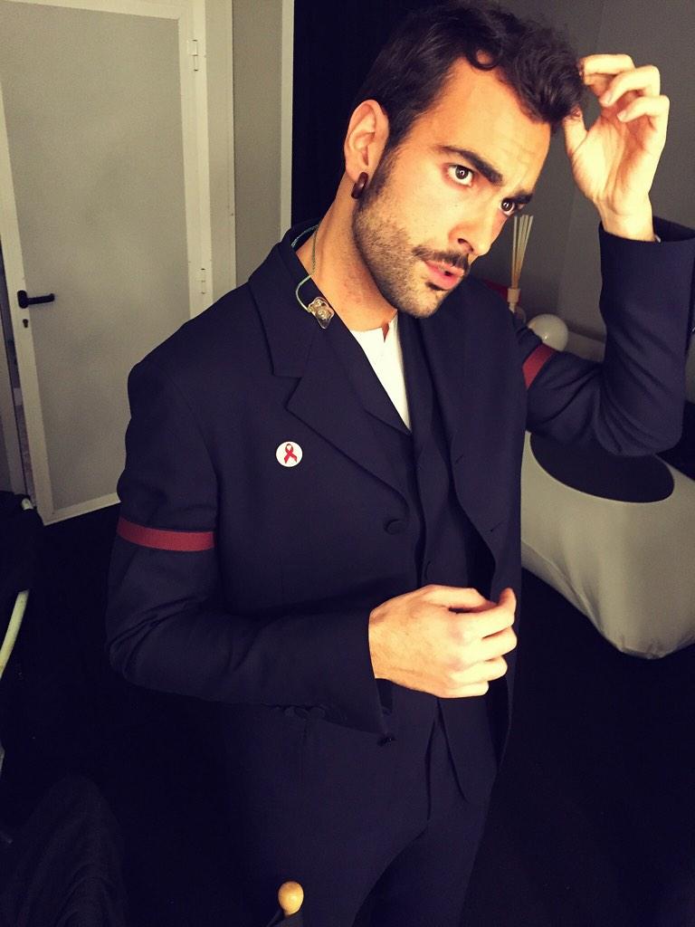 Captured backstage at X Factor Italy, Italian singer Marco Mengoni was spotted in a tailored three-piece suit from Z Zegna's fall-winter 2014 collection. The suit's colored armbands is a significant detail of this season's outing from the Italian label.