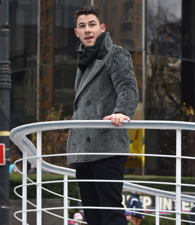 Promoting his hit single 'Jealous' off his self-titled album, Nick Jonas attended the 88th annual Macy's Thanksgiving Day Parade on November 27th in New York City. Dressed to combat the crisp day in the Big Apple, Jonas wore a faux fur double-breasted gray jacket from Italian label Emporio Armani. Jonas also wore an Armani suit to the 2014 American Music Awards.