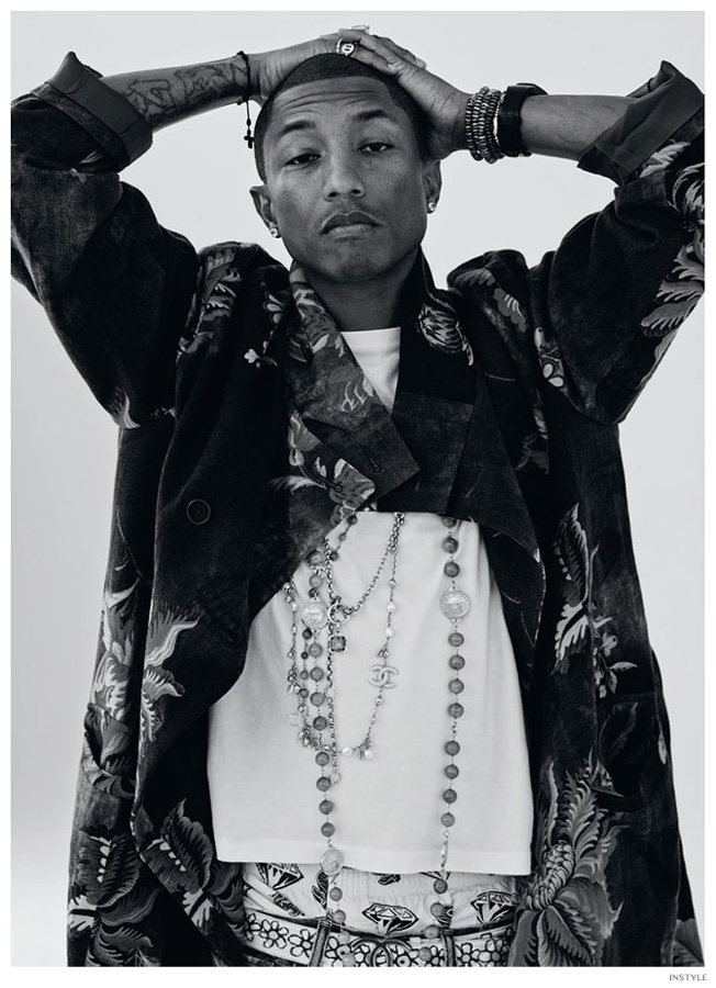 Photographed by Johan Sandberg, singer Pharrell Williams graces the pages of InStyle. Known for his decadent personal style, Williams finds a statement piece in the fall-winter 2014 collection of Japanese designer Yohji Yamamoto. Donning Yamamoto's wool print coat, Williams accessorizes with Chanel jewelry. 