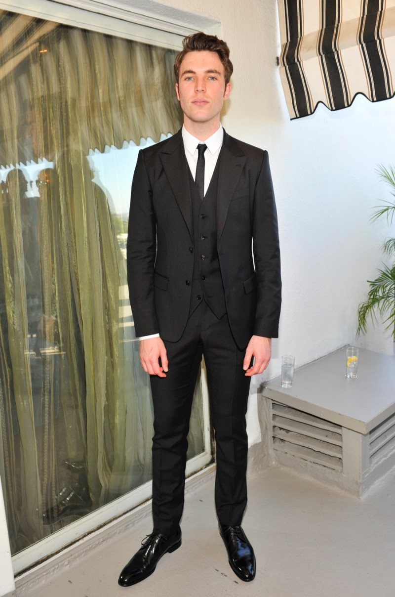 Tom Hughes dons slim-cut black suit to an afternoon tea hosted by Vanity Fair in celebration of BAFTA LA.