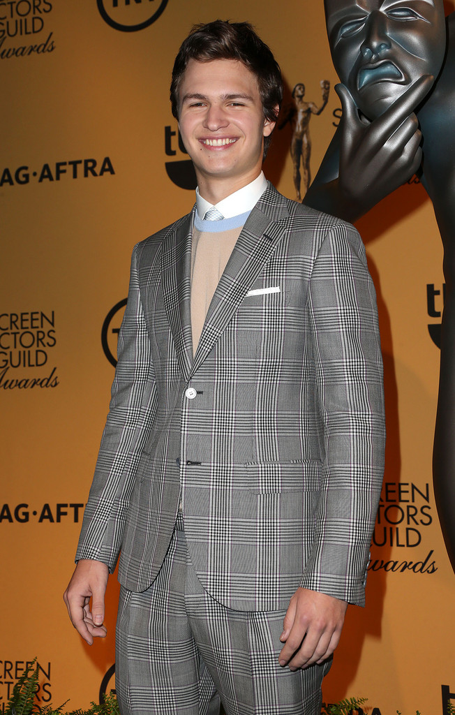 Helping announce the 21st annual Screen Actors Guild Awards Nominations in Los Angeles, California on December 10th, actor Ansel Elgort dressed to impress in a spring-summer 2015 look from Italian fashion label Brioni. Elgort sported an overprinted wool and mohair Prince of Wales suit, paired with a crewneck sweater and white cotton poplin formal shirt.