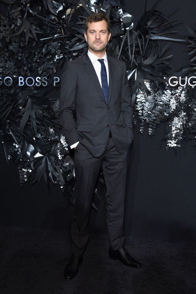 Adding a pop of color, actor Joshua Jackson sports a blue tie with a charcoal Hugo Boss suit.