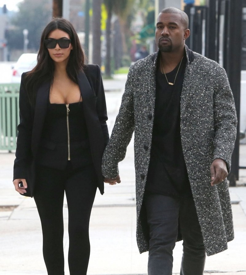Spotted out and about in Hollywood, California pre-Christmas, with his wife Kim Kardashian, rapper Kanye West enjoyed the cool weather in a laid-back pair of jeans with a tee and boots. Completing his casual look, West wore a Saint Laurent black and white tweed coat.