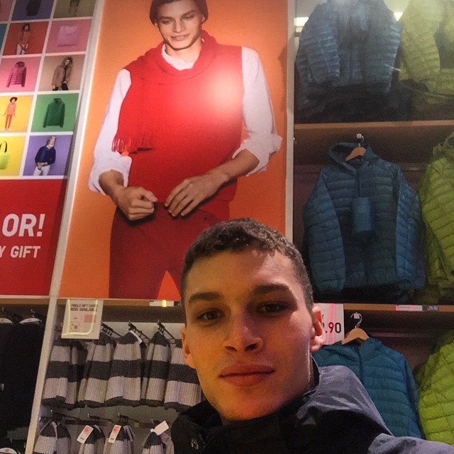 Louis Mayhew poses with his picture at UNIQLO