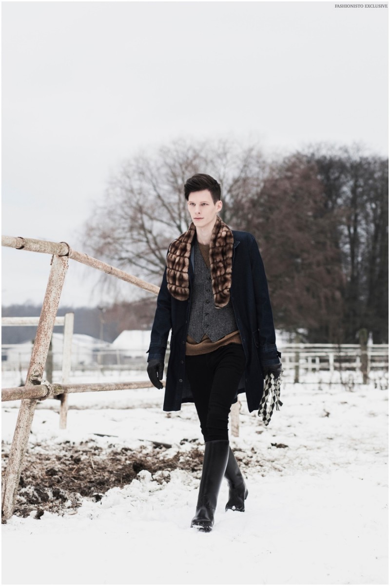 Taavi  wears faux-fur scarf / tippet vintage, waistcoat Marks & Spencer, sweater Hugo Boss, overcoat Reval Denim Guild, pants Pepe Jeans London and gloves Diesel.