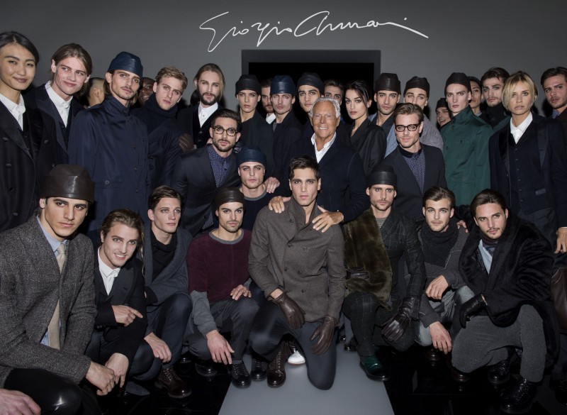 Armani takes a group photo with the models who walked for Giorgio Armani's fall-winter 2015 menswear show.