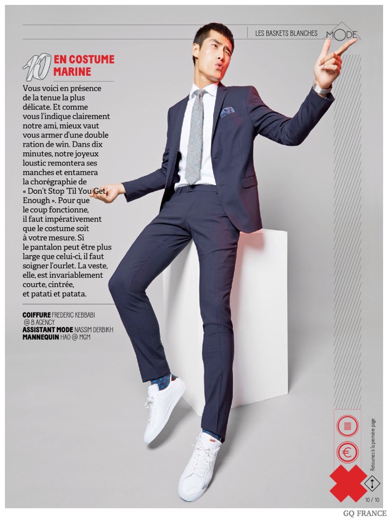 How to Wear a Suit with White Sneakers: Photographed by Taghi Naderzad, model Hao Yun Xiang graces the pages of GQ France and teaches us a thing or two about suits and white sneakers. Outfitted by stylist Laetitia Paul, Hao is effortlessly cool in a blue tailored suit with white sneakers.