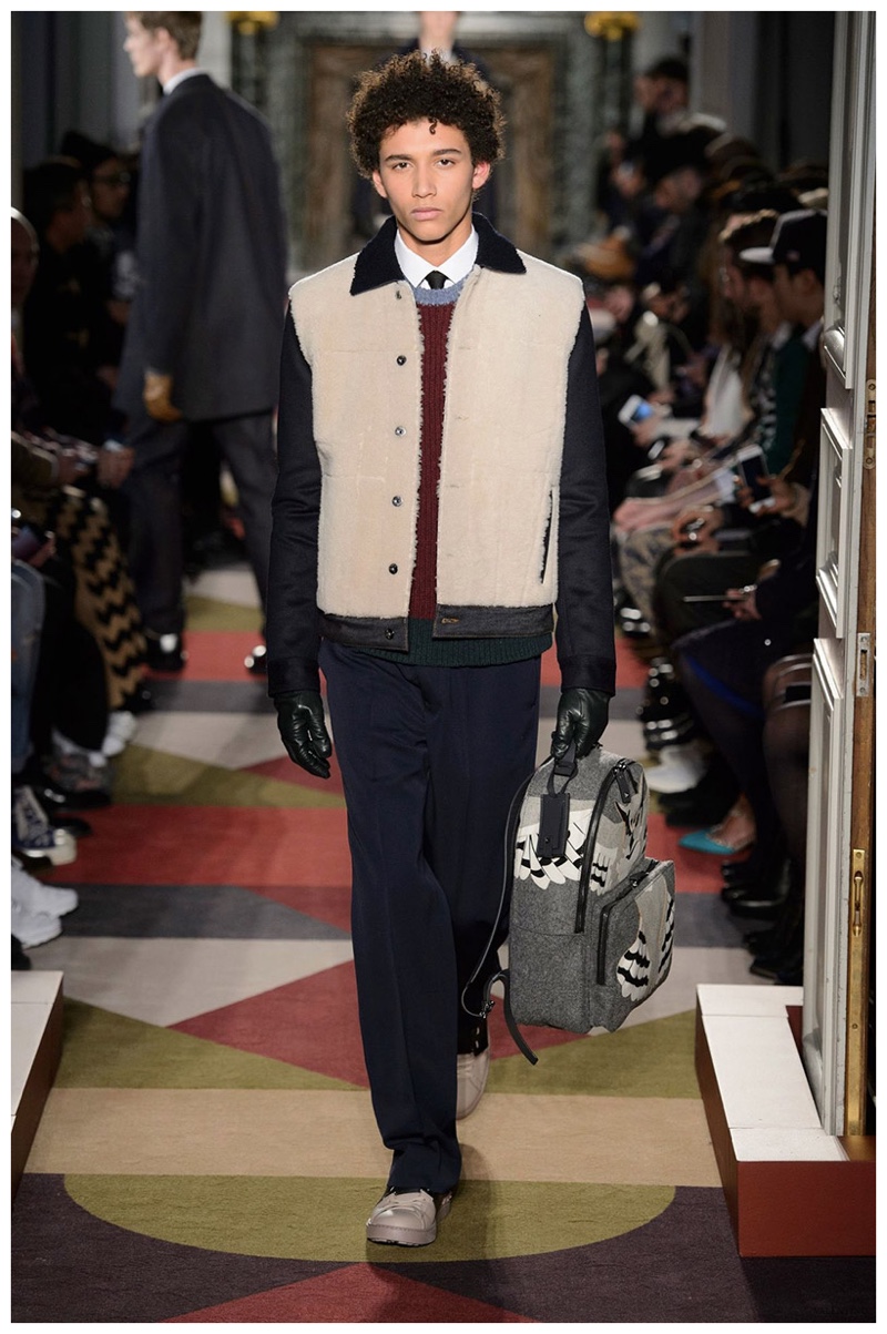 Valentino Fall-Winter 2015 Menswear Collection. Contrasting fabrics come together for Valentino's contribution to fall's shearling trend. Treated to a short jacket, Valentino's max flexes a casual approach to luxury wear.