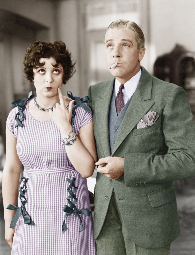 Man wearing a colorful 1920s suit complete with a printed tie and colorful handkerchief. 