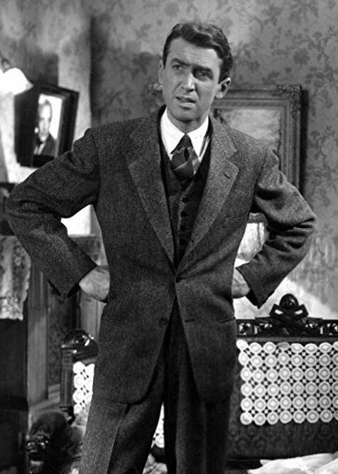 1940s Men's Fashion: A still featuring James Stewart in It's a Wonderful Life (1946). Playing George Bailey, Stewart kept his style professional in a three-piece tweed suit.