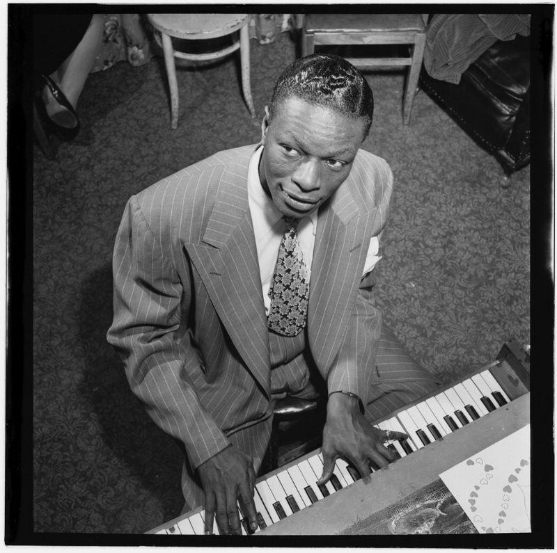 Nat King Cole in a pinstripe suit photographed in New York circa June 1947.