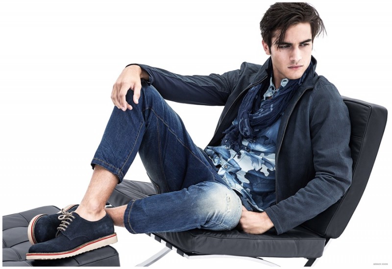 Model Aleksandar Rusic takes it easy in slim distressed jeans and a blue printed shirt from Armani Jeans.