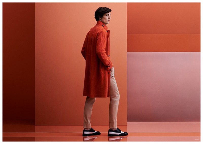 Posing with his back to the camera, Staffan Lindstrom wears a vibrant red-orange Canali coat.