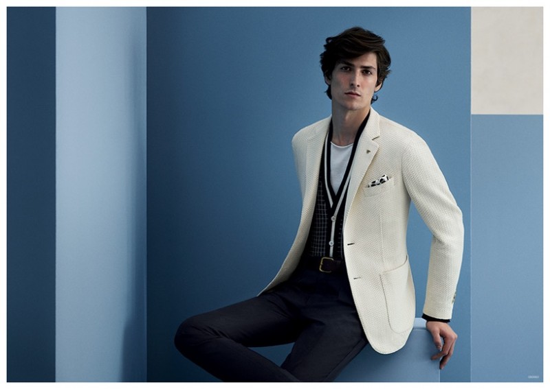 An elegant vision, Staffan Lindstrom models a white jacket paired with slim black layers.
