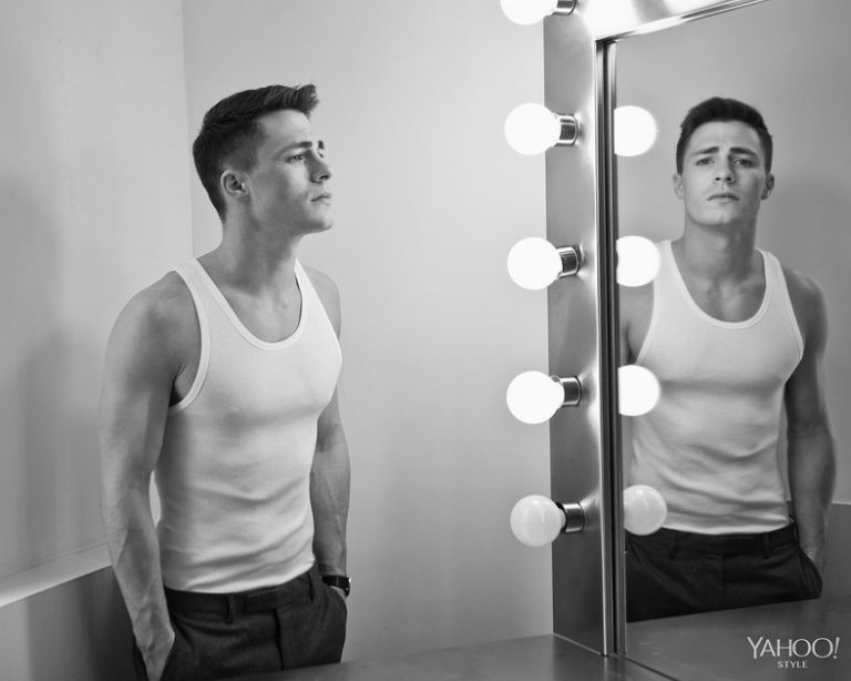 Colton Haynes is captured for a mirror image. Haynes wears Calvin Klein Underwear white ribbed tank top with charcoal GANT Rugger trousers.