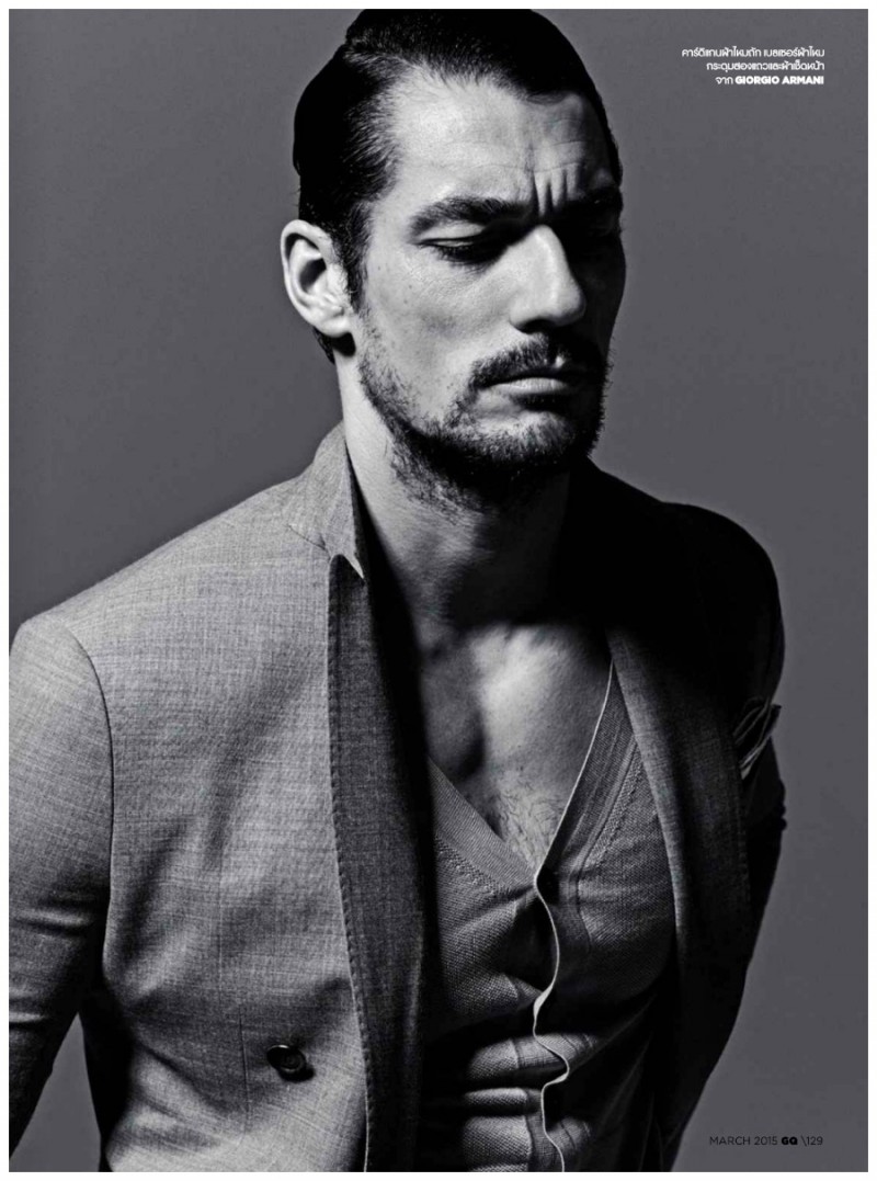 David Gandy wears a cardigan sweater with a jacket from Giorgio Armani.