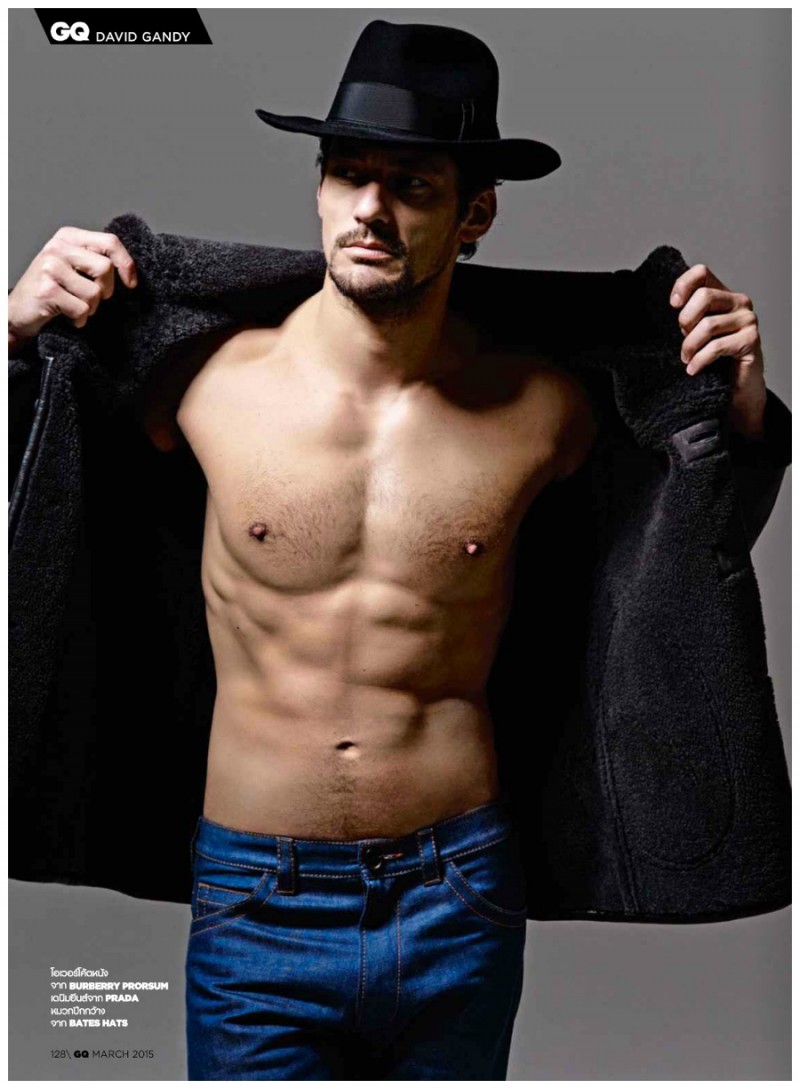 David Gandy opens his Burberry jacket to unveil his sculpted torso.