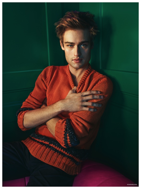 Embracing a pop of color, Douglas wears a orange Hermes sweater.