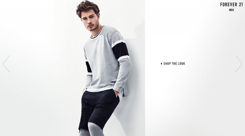 Francisco Lachowski embraces color blocking with a gray and black sweatshirt.
