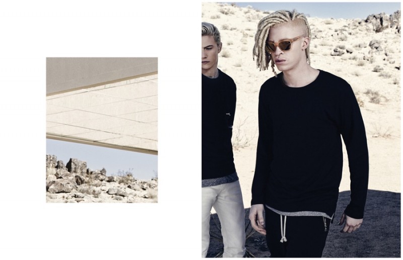 Rocking dreadlocks, Shaun Ross is pictured in a black number featuring joggers with zippered pockets.