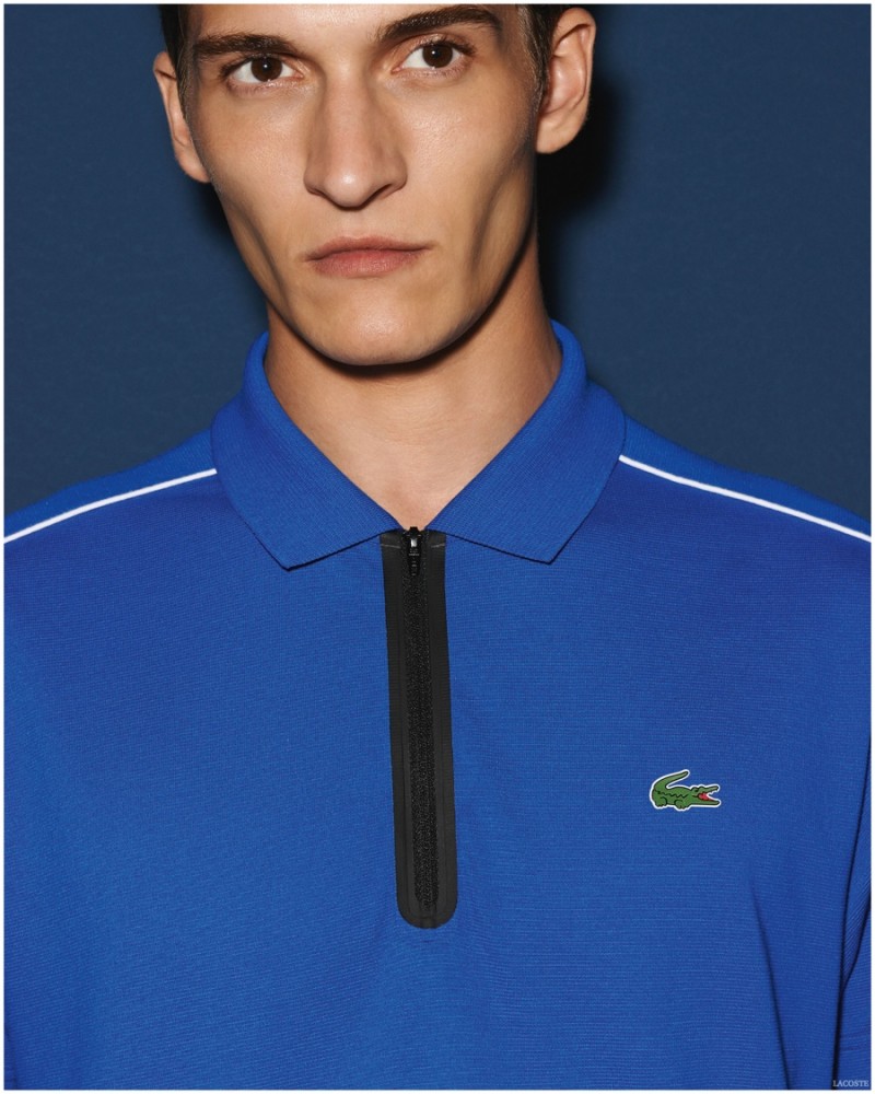 Lacoste's iconic polo shirt is updated by replacing buttons with a black zipper.